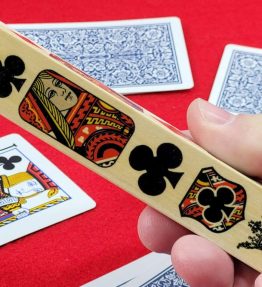 Hand holding suited marker over deck of cards