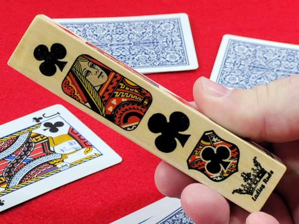 Hand holding suited marker over deck of cards