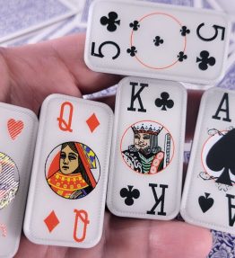 Hand holding cardian poker dominoes