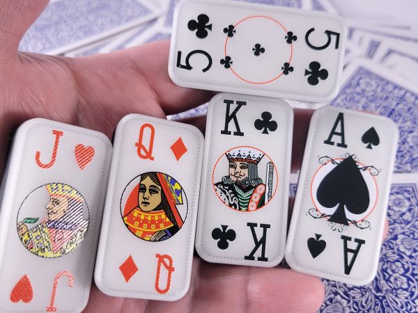 Hand holding cardian poker dominoes
