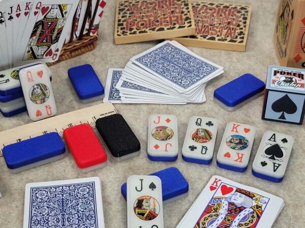 poker dominoes with normal deck of cards, ruler and poker coaste