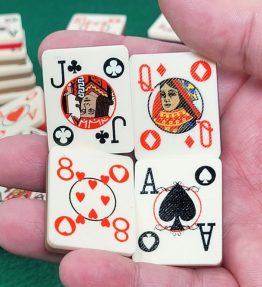 Hand holding 4 poker playing card tiles