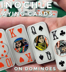 Domino pinochle playing cards held in hand