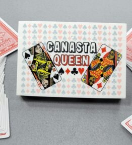68d5ab538fd207988795858a.jpg Canasta Queen Playing Card Box that features 4 queens from a deck of cards with a backdrop of pips (hearts, clubs, diamonds and spades)